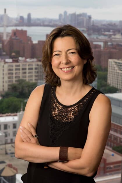 professional headshot of NYU Tandon's Dean of Engineering, Jelena Kovačević, with cityscape in background