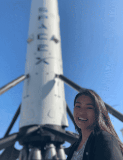 Michelle Lin standing near spacex shuttle