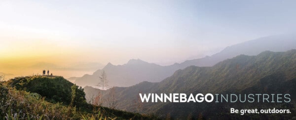 Winnebago Industries logo and tagline over a landscape mountain scene