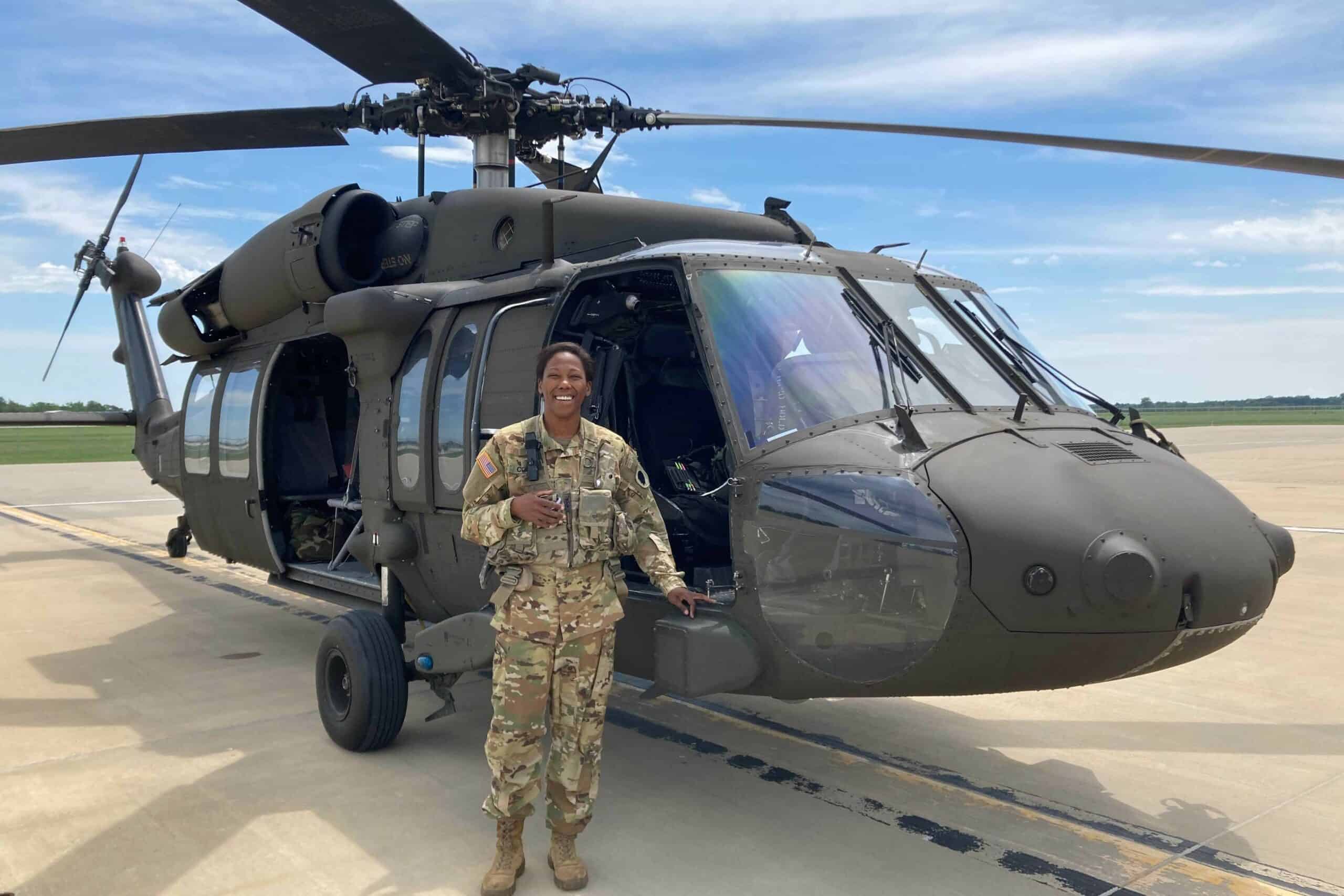 Army 2nd Lt. Gabrielle Cole poses with a UH-60 Black Hawk